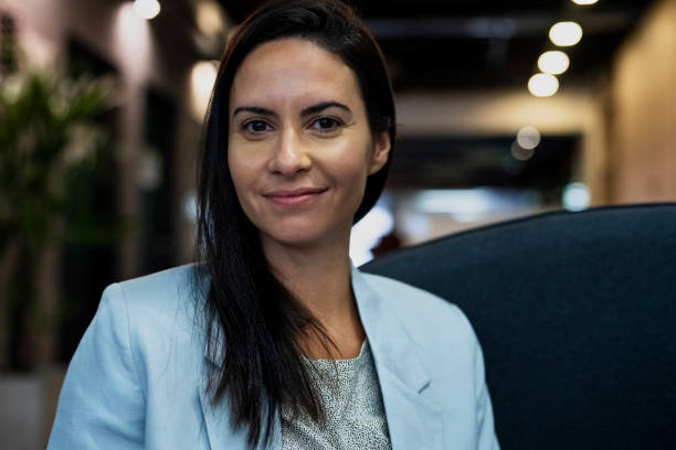 istock Confident busineswoman sitting on chair while looking at the camera 1867987356