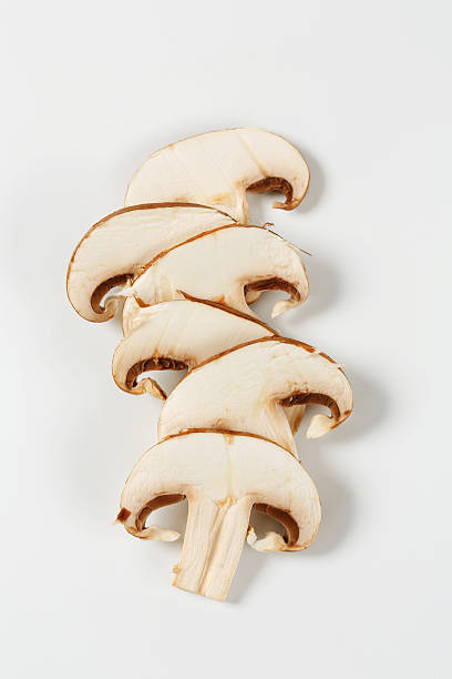 Sliced champignon mushrooms isolated on white