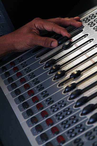 DJ mixing board with African American hand