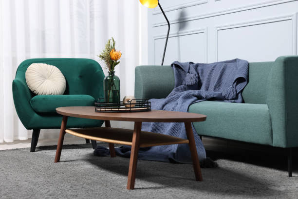 istock Comfortable sofa, blanket, table and armchair in living room 1867990173