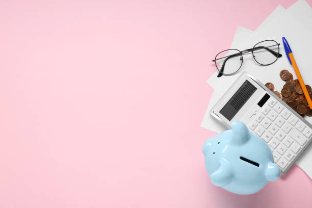 istock Flat lay composition with calculator and piggy bank on pink background. Space for text 1867993102