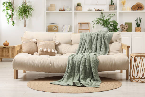 istock Stylish living room interior with comfortable sofa, blanket and side table 1867994140