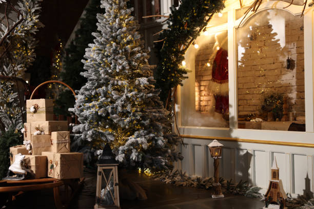istock Beautiful Christmas trees, gift boxes, skates and festive decor indoors. Interior design 1867994664