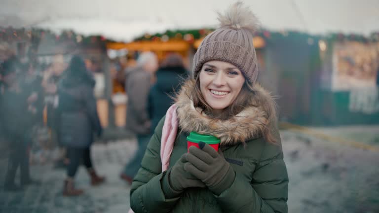 smiling woman at christmas fair in city