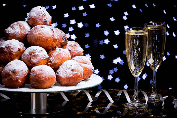 dutch new year's eve with oliebollen, a traditional pastry - oliebollen stockfoto's en -beelden