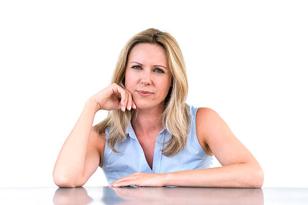 istock serious woman sitting at desk 186800671