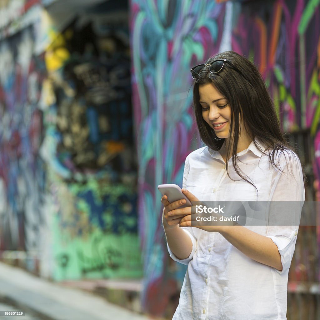 Young Woman Using a Phone Young woman using a cell phone Melbourne - Australia Stock Photo