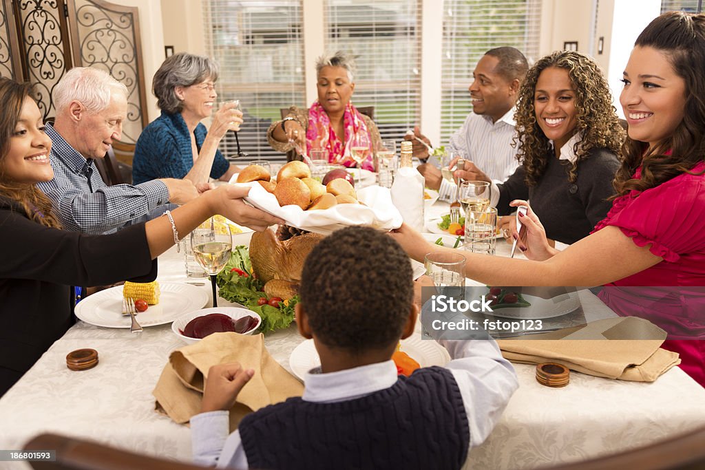 Holidays: Family and friends gather for dinner at grandma's house. Family and neighbors gather together for Thanksgiving or Christmas dinner. Family Stock Photo