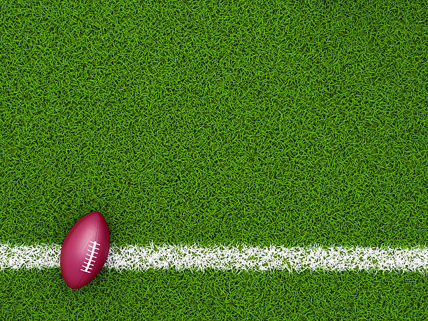 Glowing American football ball in a sports stadium or sport field as a team tournament in an arena for game playing competition as a 3D illustration.
