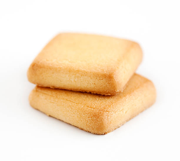 Two square shortbread cookies on a white background stock photo