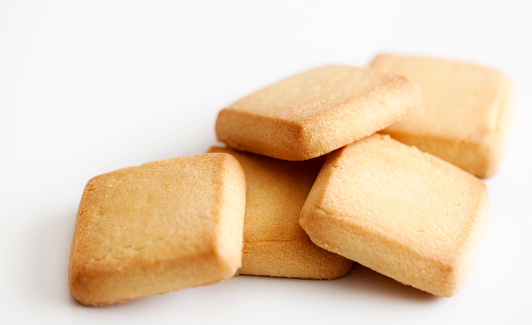 A handful of shortbread biscuits on a white background