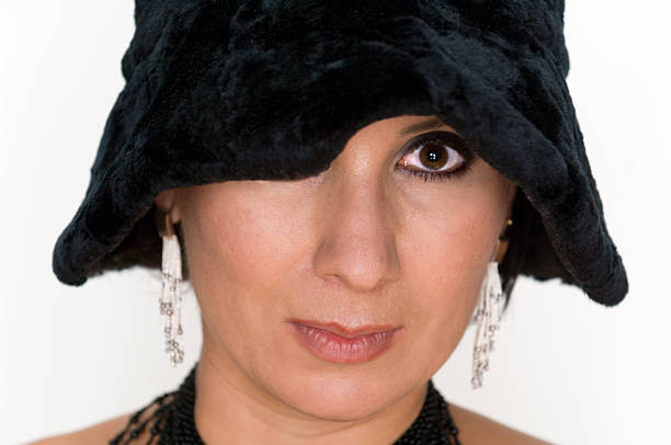 A latin woman in her 40s with a retro hat