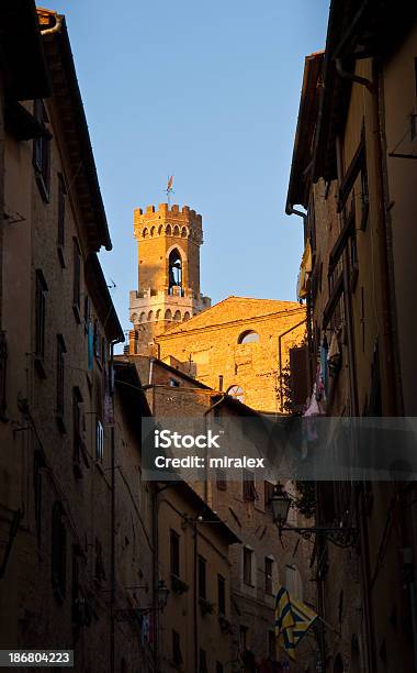 Street In Volterra With Tower Of Palazzo Dei Priori Visible Stock Photo - Download Image Now