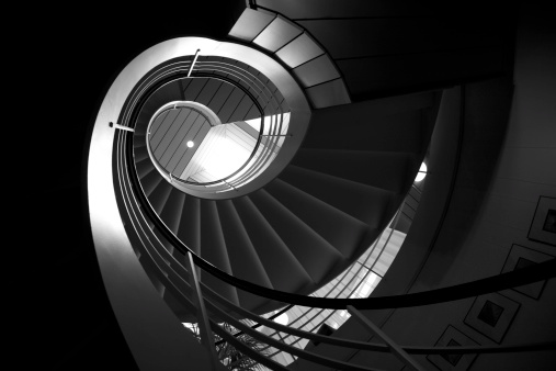 Looking up at a spiral stair case.Click here for more: