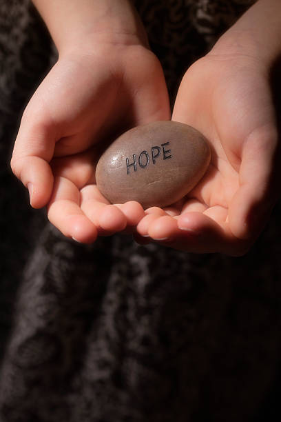 istock Hands holding a rock with the word HOPE 186804456