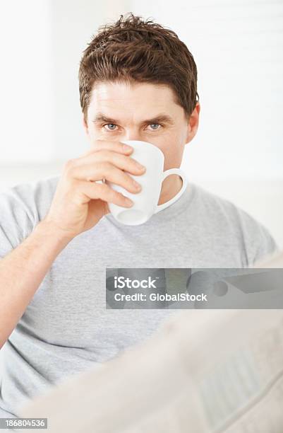 Mann Trinkt Kaffee Und Hältst Eine Zeitung Stockfoto und mehr Bilder von 35-39 Jahre - 35-39 Jahre, Blick in die Kamera, Das Leben zu Hause