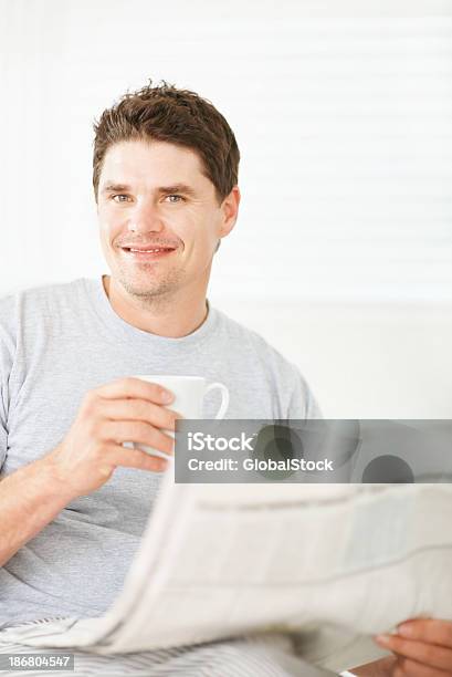 Smiling Man Holding A Coffee Cup And Newspaper Stock Photo - Download Image Now - 30-39 Years, 35-39 Years, Adult