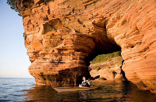 Woman Sea Kayaking Woman Sea Kayaking in Apostle Islands. bayfield county stock pictures, royalty-free photos & images