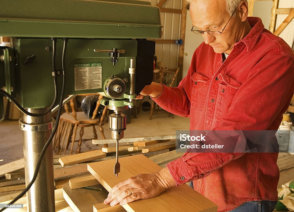 Carpenter drilling a hole  Cross Section Stock Photo