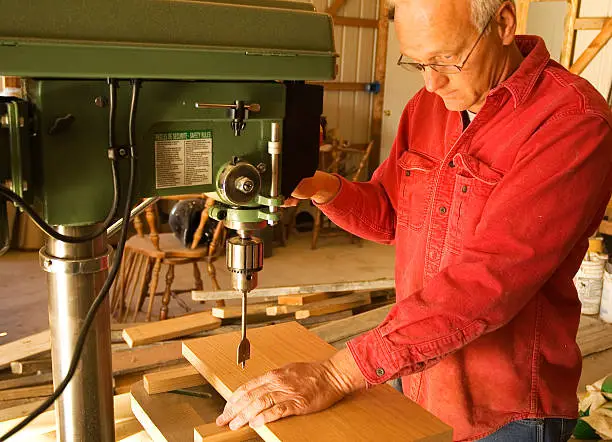 Photo of Carpenter drilling a hole