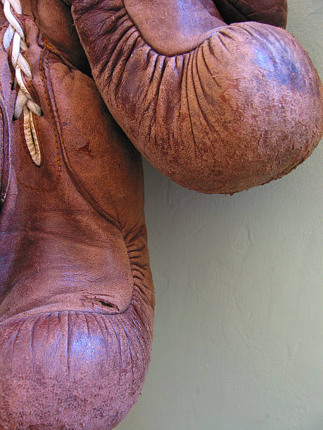 Boxing Gloves Images of a very old pair of boxing gloves lightweight weight class stock pictures, royalty-free photos & images