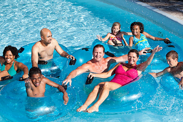 istock Group of people on innertubes at water park 186805768