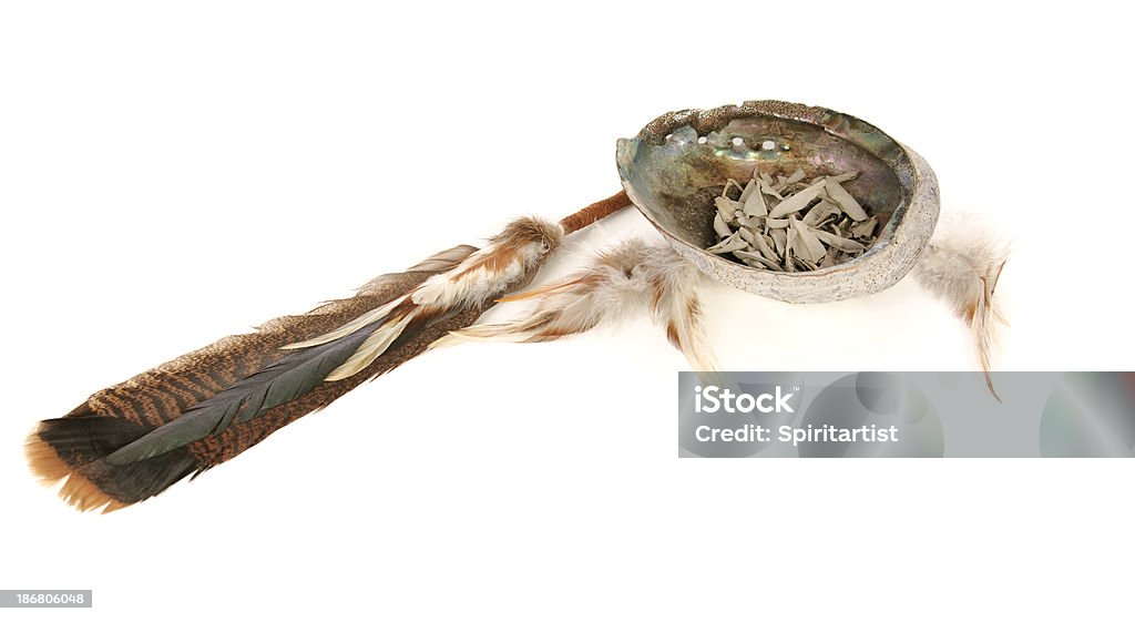 Sacred Sage And Smudging Tools "The burning of sage, called smudging, has been used for spiritual cleansing and healing by Native Americans and other tribal cultures for centuries.  The smoke of the dried leaves is fanned out to purify and restore positive healing energy to rooms, objects, people, plants and animals. Pictured here is a feather fan, an abalone shell and white sage." Guru Stock Photo