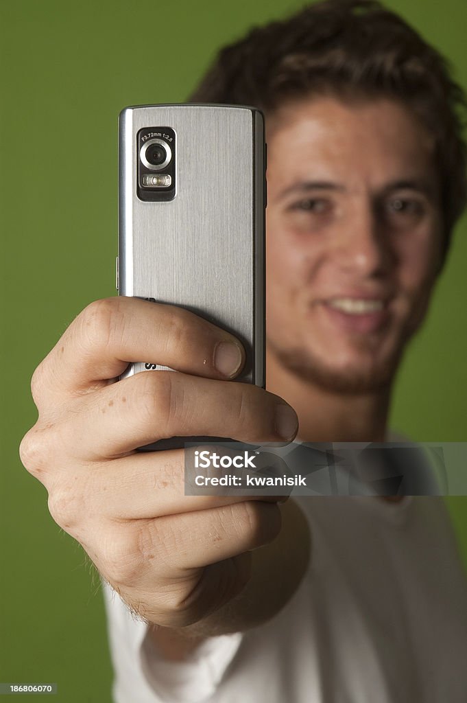 Young man taking a picture with her camera phone. 20-29 Years Stock Photo