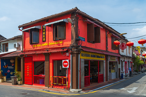 Jalan Tun Tan Cheng Lock, Malacca City, Malaysia - February 28th 2018: A restaurant in a red coloured building on corner with Jalan Hang Kasturi.
