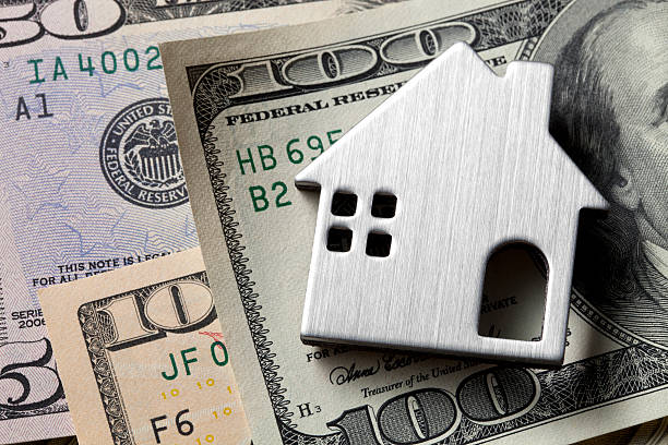 istock Miniature model house on dollar bills. 186806730