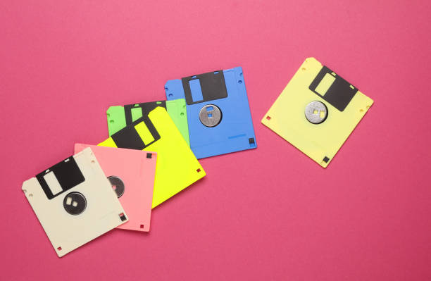 istock Many colored floppy disks on pink background. Computer technology 80s. Top view. 1868069933