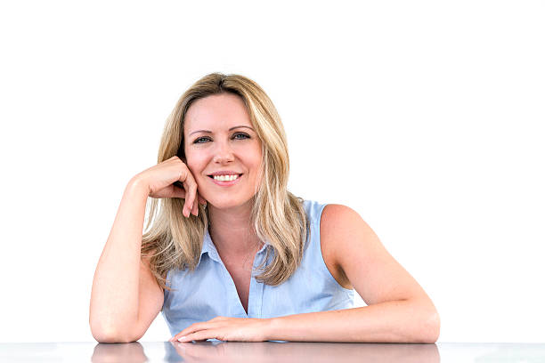 istock happy woman sitting at desk 186807498