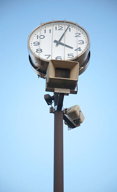 istock Outdoor clock with public address system speakers 186807897
