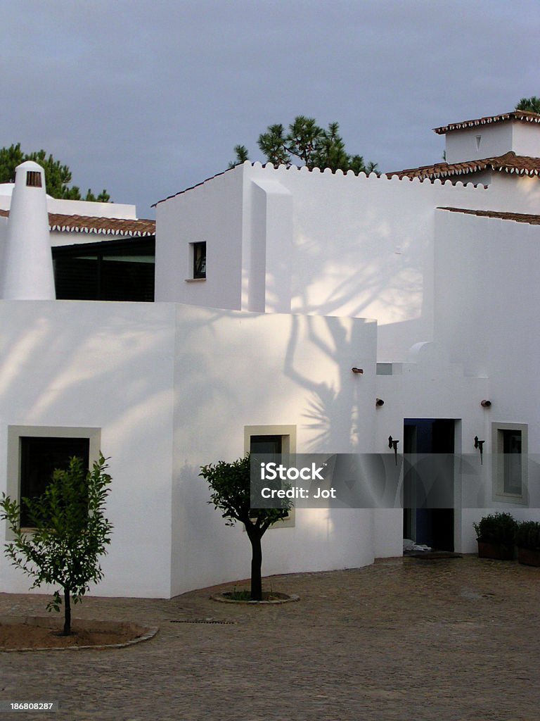 Portugal - Courtyard, Algarve, Evening "A courtyard in the Algarve, Portugal. Evening with dark sky and shadows" Adobe - Material Stock Photo