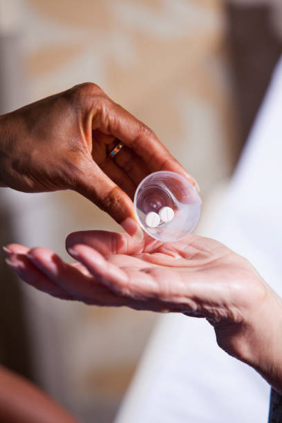 istock Hand of nurse giving patient medication 186808300
