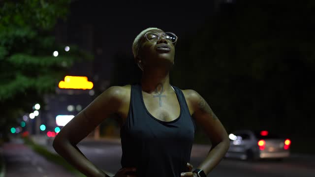A young woman exercising at night breathing