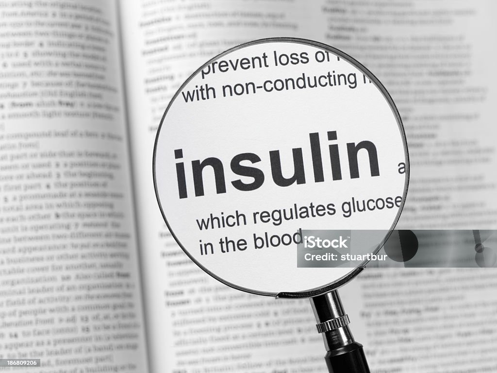 Medical book with the word insulin magnified dictionary highlighting insulin Insulin Stock Photo