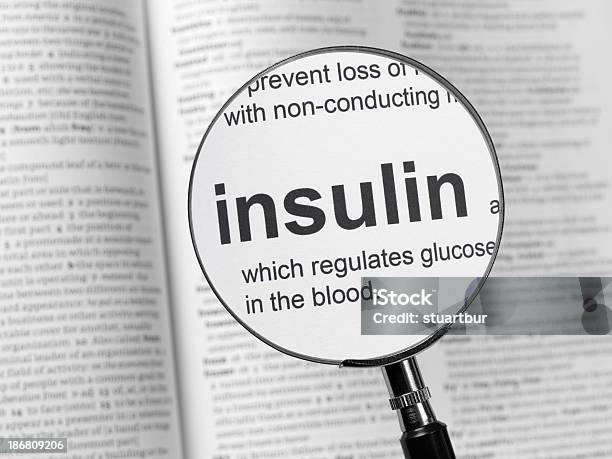 Medical Book With The Word Insulin Magnified Stock Photo - Download Image Now - Insulin, Single Word, Diabetes