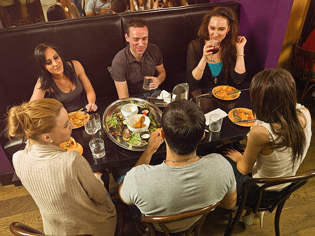 istock Friends socializing at a restaurant 186809351