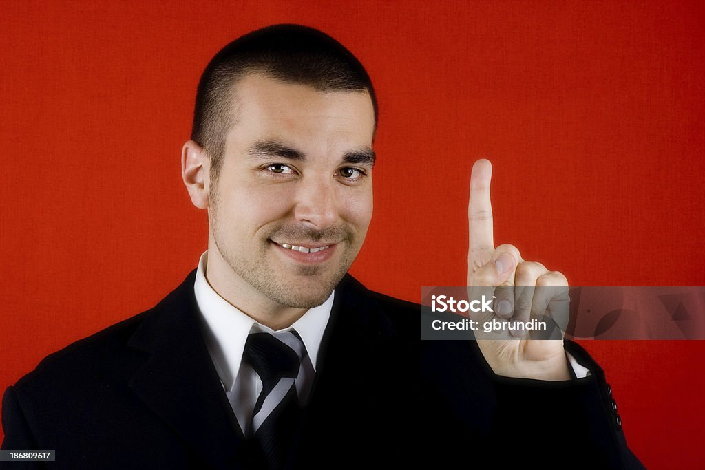 Number one Smiling businessman showing one finger.Similar photos in my portfolio: Adult Stock Photo