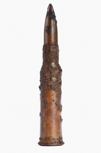 Macro of a 7.62 mm old bullet isolated on a white background
