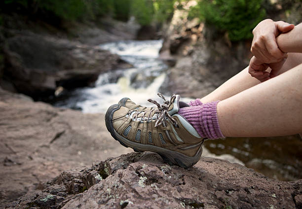 istock Hiker relaxing in boulders by a water creek 186809846