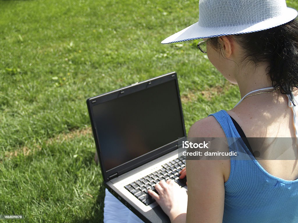 Young woman working on laptop outdoor young woman working on laptop outdoor Adult Stock Photo