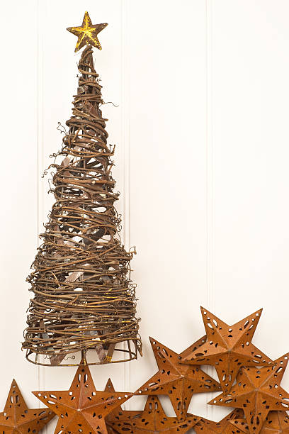 istock Metal christmas tree with rusty star decorations against panelled wall 186810089