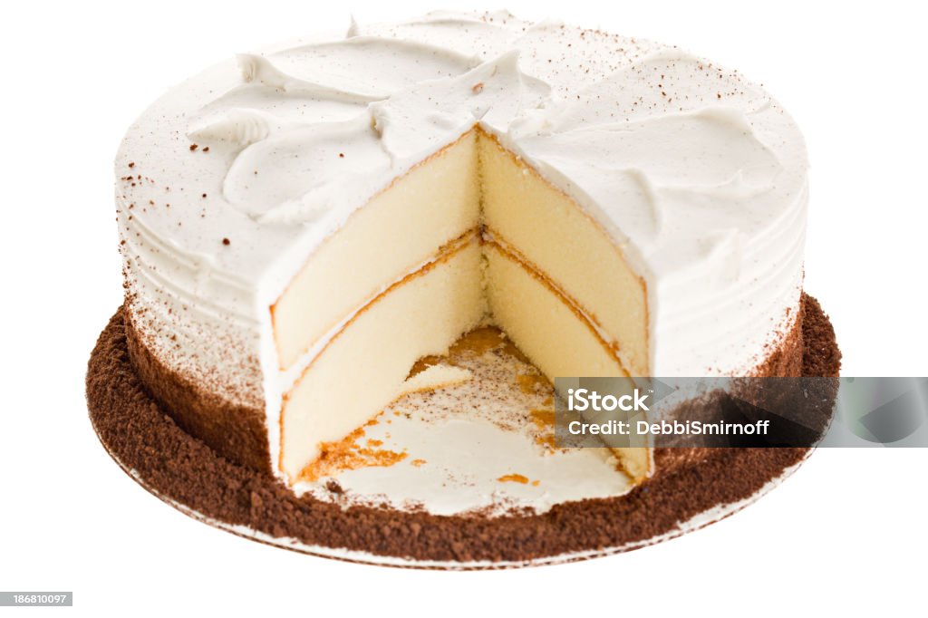 White Cake Slice Missing A high angle close up of a white cake with a white vanilla and creme cheese frosting with a large slice missing. Isolated on white. Cake Stock Photo