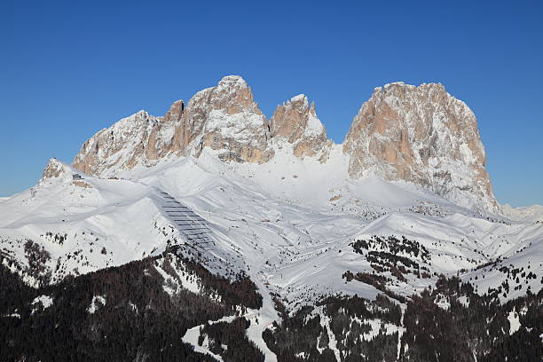 The Col Rodella Ski arena, Dolomites and above it from left Sasso Piatto (Plattkofel) 2.956 metres and Sassolungo (Langkofel) 3.181 metres close to Canazei.