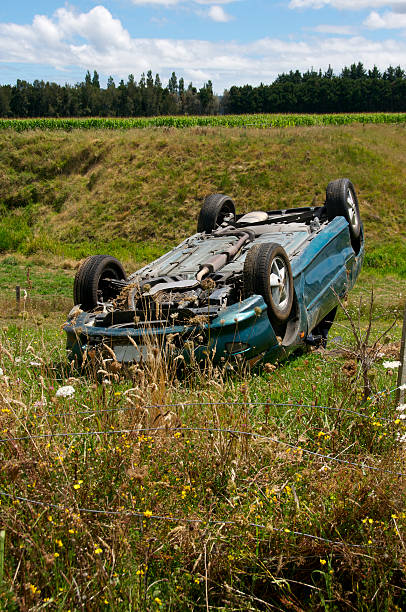 car accident the car is lying upside down on the roof in a ditch. property insurance concept. natural light.