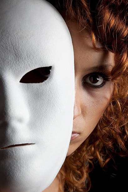 istock Woman face behind mask 186811040