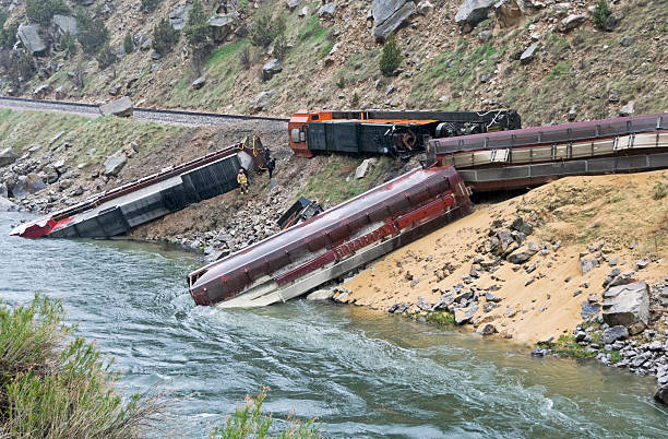 Train derailed by rock slide in Wyoming Locomotives and grain cars derailed by rock slide leaking diesel fuel into river in Wyoming derail stock pictures, royalty-free photos & images