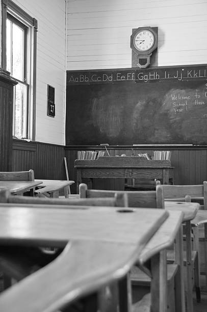 istock Old Classroom with desks in black and white 186811988